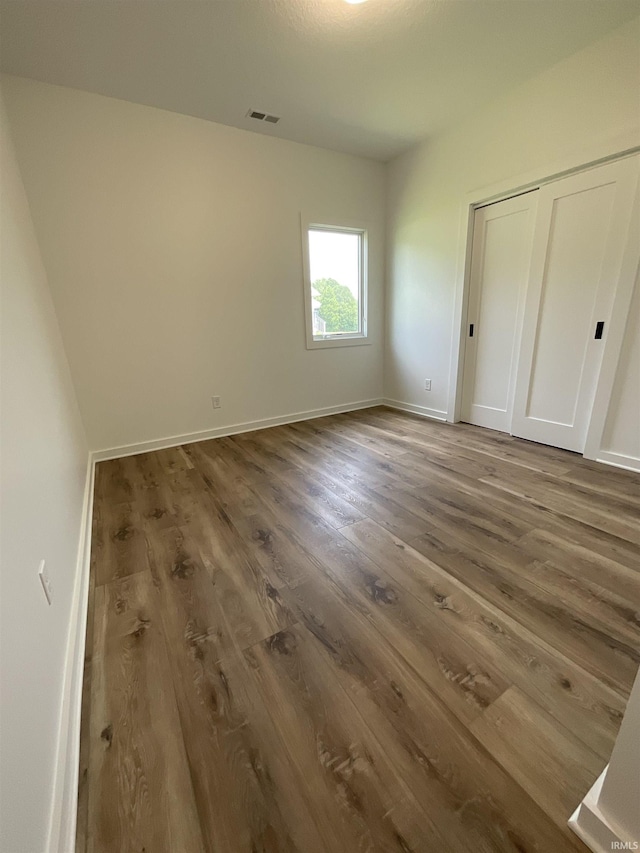 1609 Diane Dr, Ossian, IN 46777 - unfurnished bedroom featuring wood finished floors and a closet