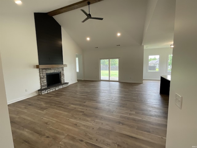 1609 Diane Dr, Ossian, IN 46777 - unfurnished living room featuring a ceiling fan, healthy amount of natural light, high vaulted ceiling, beam ceiling, and wood finished floors