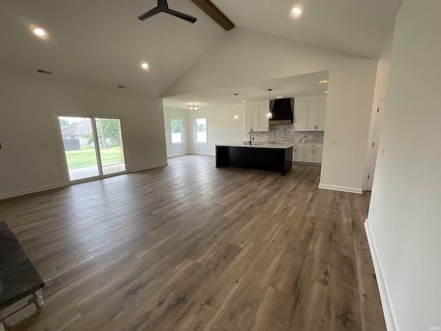 1609 Diane Dr, Ossian, IN 46777 - unfurnished living room with beamed ceiling, a ceiling fan, high vaulted ceiling, dark wood finished floors, and recessed lighting