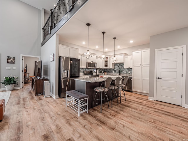 8675 Pebble Creek Dr, Newburgh, IN 47630 - kitchen featuring stainless steel appliances, a kitchen breakfast bar, a center island, white cabinets, and recessed lighting
