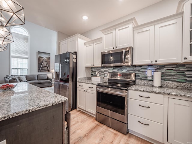 8675 Pebble Creek Dr, Newburgh, IN 47630 - kitchen with appliances with stainless steel finishes, backsplash, white cabinets, light stone countertops, and recessed lighting