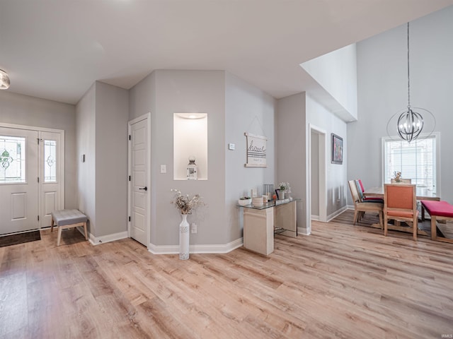 8675 Pebble Creek Dr, Newburgh, IN 47630 - foyer entrance with light wood-style flooring and a chandelier