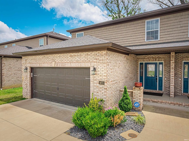 8675 Pebble Creek Dr, Newburgh, IN 47630 - view of front of property featuring brick siding, a garage, and roof with shingles