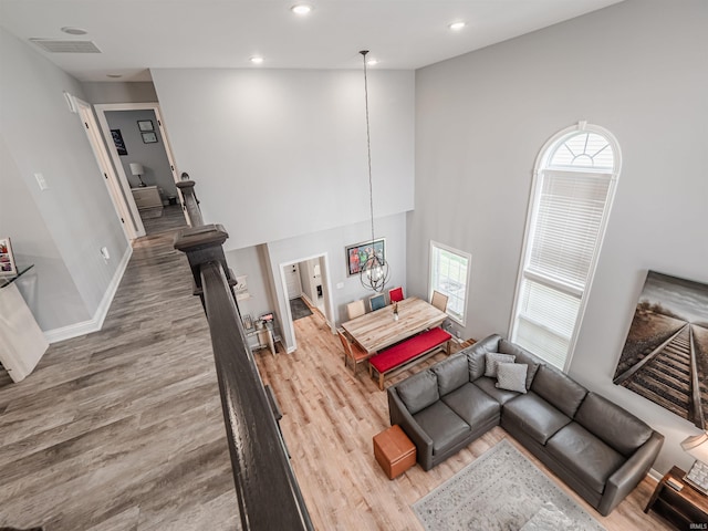 8675 Pebble Creek Dr, Newburgh, IN 47630 - living area featuring wood finished floors, recessed lighting, and a towering ceiling