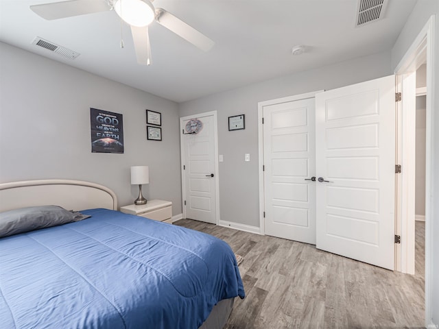 8675 Pebble Creek Dr, Newburgh, IN 47630 - bedroom with wood finished floors, ceiling fan, and a closet