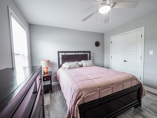 8675 Pebble Creek Dr, Newburgh, IN 47630 - bedroom with dark wood finished floors, a ceiling fan, and a closet