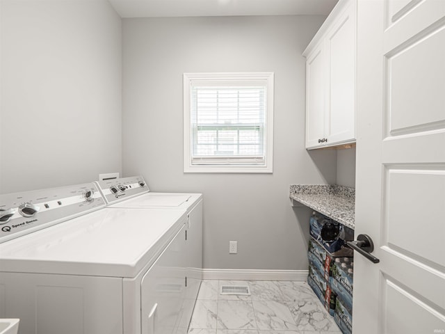 8675 Pebble Creek Dr, Newburgh, IN 47630 - washroom featuring washing machine and dryer, cabinet space, and light marble finish flooring