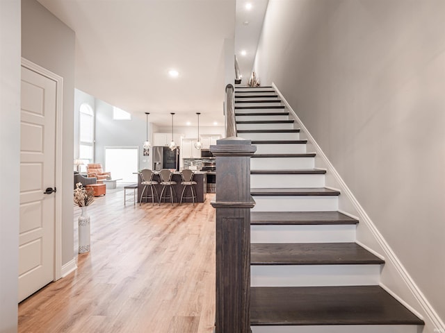 8675 Pebble Creek Dr, Newburgh, IN 47630 - stairway with wood finished floors and recessed lighting