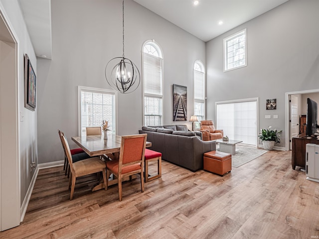 8675 Pebble Creek Dr, Newburgh, IN 47630 - dining room featuring a towering ceiling, a chandelier, light wood-style floors, and recessed lighting