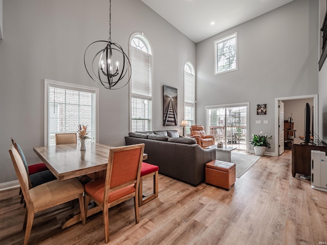 8675 Pebble Creek Dr, Newburgh, IN 47630 - dining room featuring a high ceiling, a chandelier, light wood-style flooring, and recessed lighting