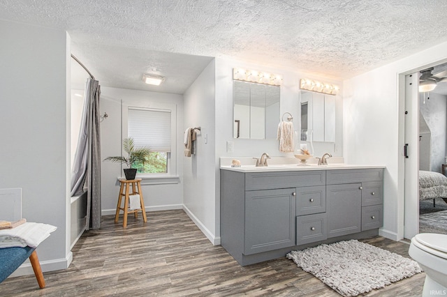 914 Golden Ave, South Bend, IN 46616 - bathroom with wood finished floors, double vanity, and a textured ceiling