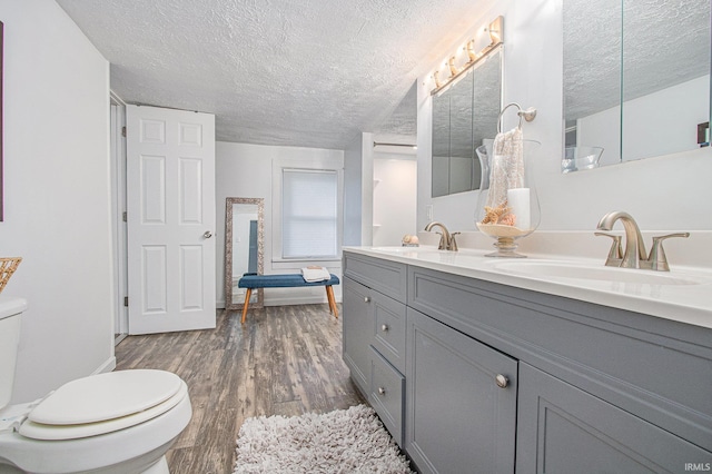 914 Golden Ave, South Bend, IN 46616 - full bathroom with a textured ceiling, double vanity, and wood finished floors