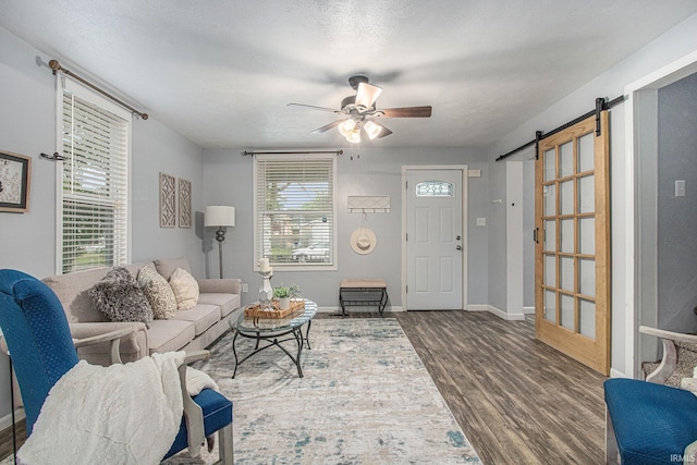 914 Golden Ave, South Bend, IN 46616 - living area featuring wood finished floors, a barn door, and a ceiling fan