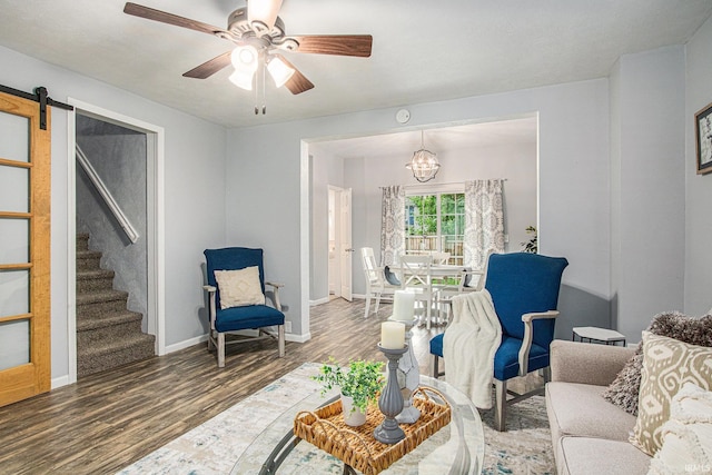 914 Golden Ave, South Bend, IN 46616 - living area featuring wood finished floors, a chandelier, stairway, ceiling fan, and a barn door