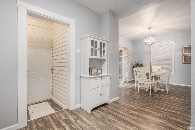 914 Golden Ave, South Bend, IN 46616 - dining room with a chandelier, wood finished floors, and a textured ceiling