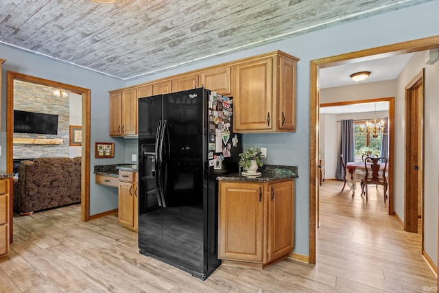 32750 Deer Watch Ct, New Carlisle, IN 46552 - kitchen with black fridge with ice dispenser, a chandelier, light wood-style flooring, wood ceiling, and dark stone counters