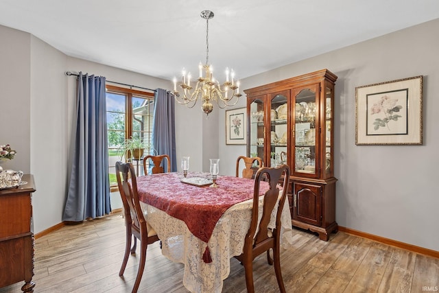 32750 Deer Watch Ct, New Carlisle, IN 46552 - dining space featuring light wood finished floors and a chandelier