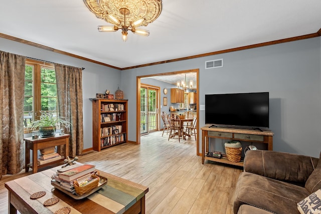 32750 Deer Watch Ct, New Carlisle, IN 46552 - living room featuring a chandelier, light wood finished floors, healthy amount of natural light, and ornamental molding