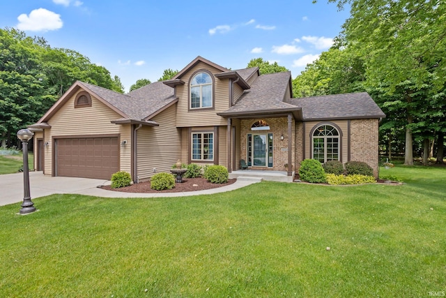32750 Deer Watch Ct, New Carlisle, IN 46552 - view of front of property featuring roof with shingles, concrete driveway, a front yard, a garage, and brick siding
