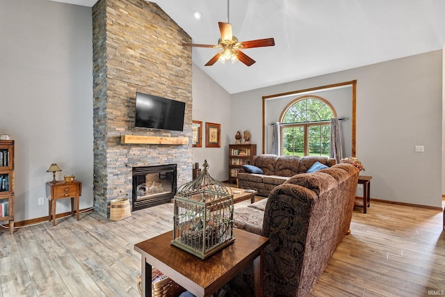 32750 Deer Watch Ct, New Carlisle, IN 46552 - living room with a ceiling fan, light wood-style floors, high vaulted ceiling, and a stone fireplace