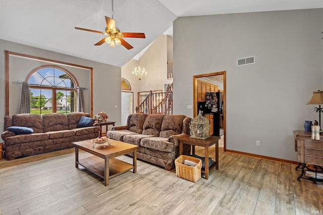 32750 Deer Watch Ct, New Carlisle, IN 46552 - living area featuring high vaulted ceiling, a ceiling fan, light wood-style floors, stairs, and a chandelier