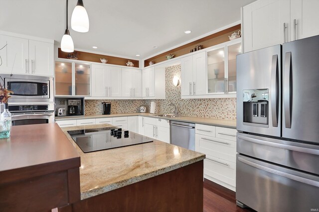 2910 E Winston St, Bloomington, IN 47401 - kitchen with stainless steel appliances, decorative backsplash, pendant lighting, glass insert cabinets, and white cabinetry