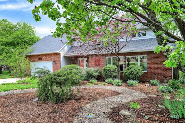 2910 E Winston St, Bloomington, IN 47401 - view of front of house with brick siding, roof with shingles, and a garage