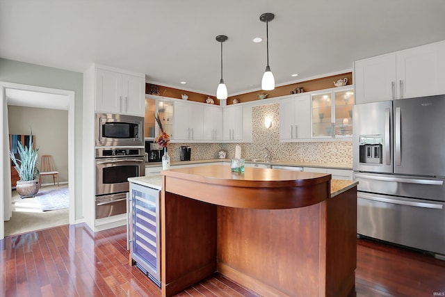 2910 E Winston St, Bloomington, IN 47401 - kitchen with stainless steel appliances, beverage cooler, a warming drawer, glass insert cabinets, and light countertops