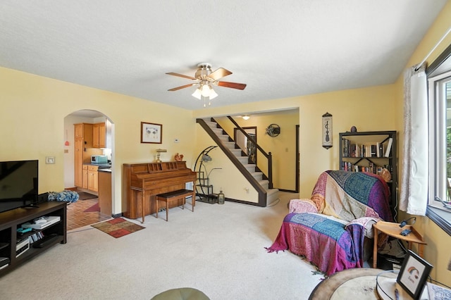 2707 Stanford Ave, Fort Wayne, IN 46808 - carpeted living area with arched walkways, a ceiling fan, and stairs
