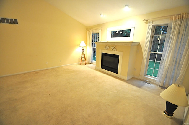 14689 Adams Rd, Granger, IN 46530 - unfurnished living room with a glass covered fireplace, vaulted ceiling, and carpet floors