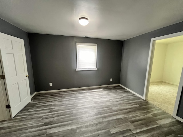 410 N Jay St, Kokomo, IN 46947 - unfurnished bedroom with dark wood-style flooring and baseboards
