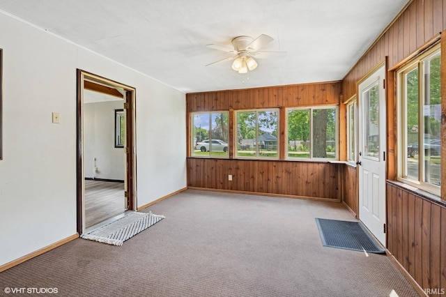 19629 Gilmer St, South Bend, IN 46614 - unfurnished sunroom with healthy amount of natural light, wood walls, and carpet floors