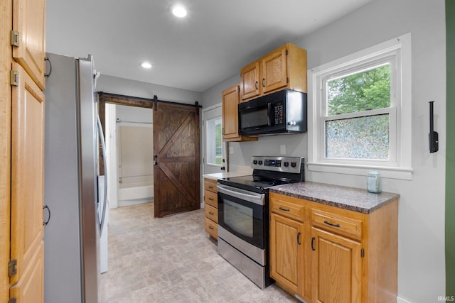 718 N Cedar St, Auburn, IN 46706 - kitchen with appliances with stainless steel finishes, a barn door, and recessed lighting