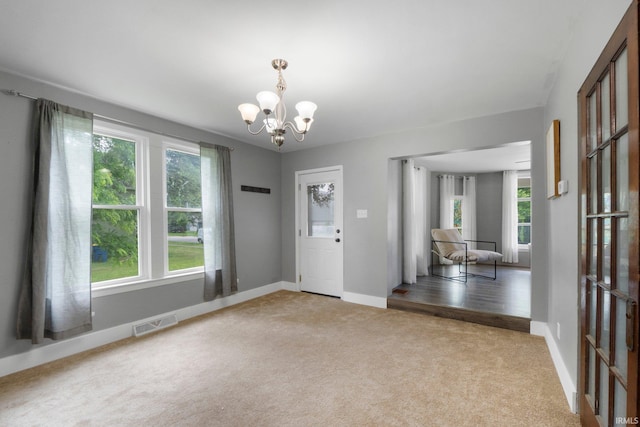 718 N Cedar St, Auburn, IN 46706 - foyer with carpet flooring and a chandelier