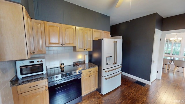 325 W 5th St, Jasper, IN 47546 - kitchen with stainless steel range with electric stovetop, light brown cabinets, white fridge with ice dispenser, dark wood-style flooring, and a chandelier