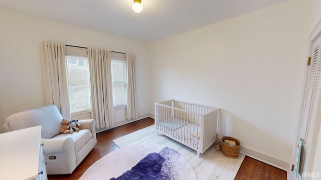 325 W 5th St, Jasper, IN 47546 - bedroom featuring a crib and wood finished floors