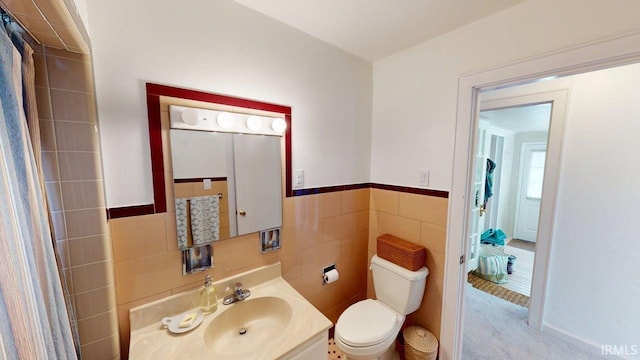 325 W 5th St, Jasper, IN 47546 - bathroom featuring tile walls, vanity, a shower with curtain, and a wainscoted wall