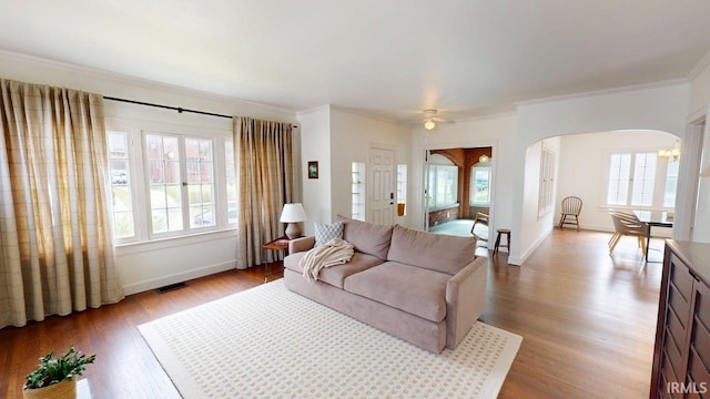 325 W 5th St, Jasper, IN 47546 - living room with arched walkways, plenty of natural light, wood finished floors, ornamental molding, and ceiling fan