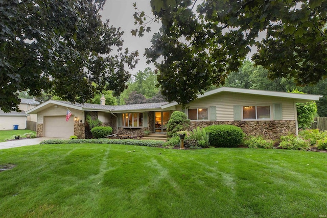 12069 N Timberline Trce, Granger, IN 46530 - single story home featuring stone siding, a front yard, an attached garage, a porch, and concrete driveway