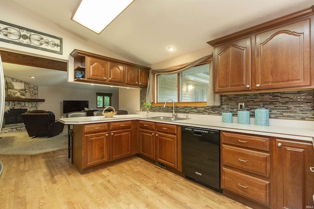 12069 N Timberline Trce, Granger, IN 46530 - kitchen featuring black dishwasher, lofted ceiling, a peninsula, light wood-style floors, and light countertops