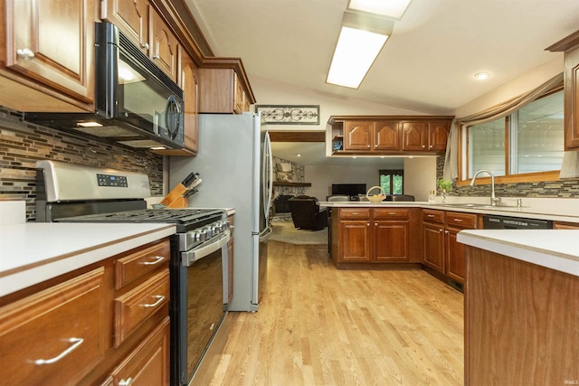 12069 N Timberline Trce, Granger, IN 46530 - kitchen with stainless steel gas range, black microwave, light countertops, backsplash, and light wood-type flooring