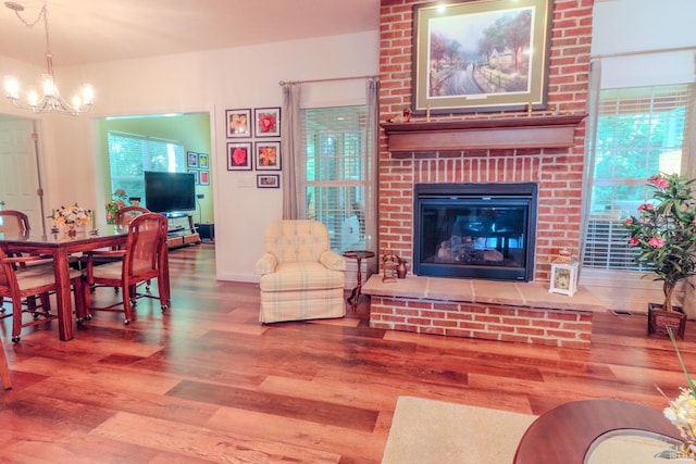 3 Cobblestone Ct, Delphi, IN 49623 - living room with wood finished floors, a chandelier, and a fireplace