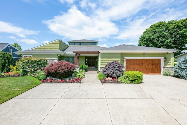 51257 Blue Ribbon Ln, Elkhart, IN 46514 - view of front of property featuring stone siding, concrete driveway, a garage, and a front yard