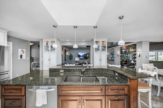 51257 Blue Ribbon Ln, Elkhart, IN 46514 - kitchen with a kitchen bar, hanging light fixtures, glass insert cabinets, and white cabinetry