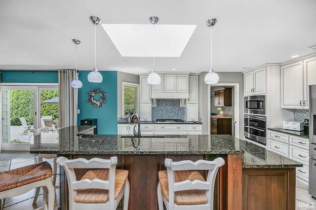 51257 Blue Ribbon Ln, Elkhart, IN 46514 - kitchen featuring appliances with stainless steel finishes, backsplash, a breakfast bar, and plenty of natural light