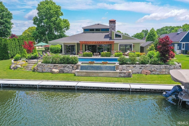 51257 Blue Ribbon Ln, Elkhart, IN 46514 - back of property with an outdoor pool, a water view, a chimney, a patio, and a yard