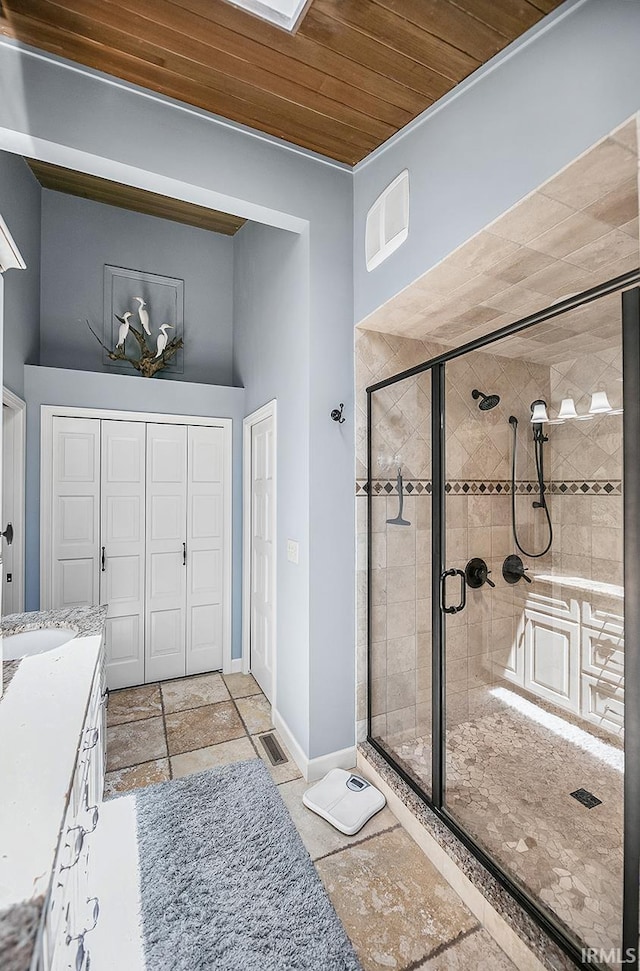 51257 Blue Ribbon Ln, Elkhart, IN 46514 - full bath with wood ceiling, a stall shower, vanity, and stone tile flooring