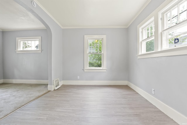 407 W Branning Ave, Fort Wayne, IN 46807 - empty room with healthy amount of natural light, crown molding, arched walkways, and wood finished floors