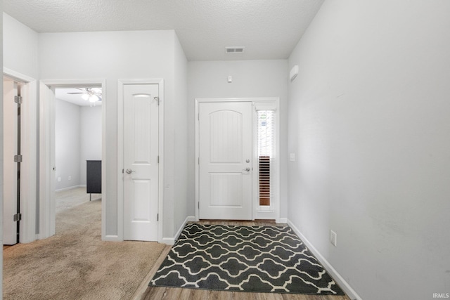 13233 Mera Cv, Fort Wayne, IN 46814 - foyer entrance with a textured ceiling, carpet flooring, and a ceiling fan