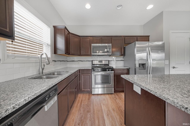 13233 Mera Cv, Fort Wayne, IN 46814 - kitchen with stainless steel appliances, light wood-style floors, tasteful backsplash, dark brown cabinetry, and recessed lighting